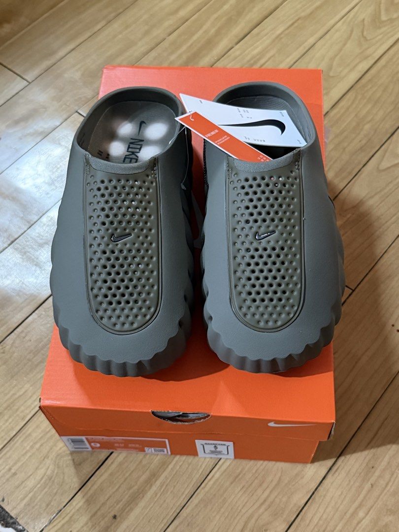 Nike Mind Olive Green Mules Size 9 (Category: Slippers & Slides) located in Quezon City. Submitted by she_101279 (Listing ID 1468564712, Image 1). Description: - Brand: Nike Mind Mules - Color: Olive Green - Size: US 9 / Womens - Condition: Brand new with tags and original orange box - Design details: Perforated top panels, textured sides with Nike swoosh, and unique bulbous sole.