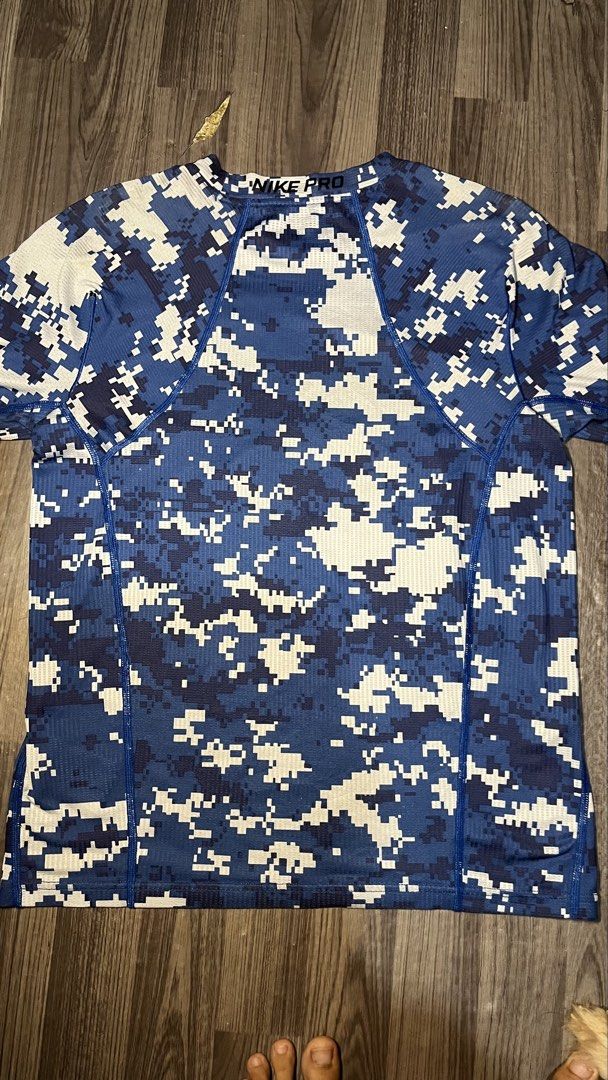 Nike Pro Hypercool Digital Camo Fitted Shirt Size L (Category: Activewear) located in Caloocan City. Submitted by lucky_jhonel (Listing ID 1468658174, Image 2). Description: - Brand: Nike Pro Hypercool - Style: Fitted workout shirt with blue digital camo pattern and black Nike swoosh - Size: Men's Large (L) - Material: Body (86% polyester, 14% spandex); Back/Underarm panels (88% polyester, 12% spandex) - Features: Highly breathable mesh fabric th