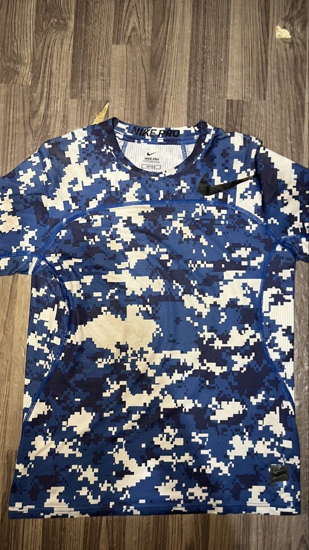 Nike Pro Hypercool Digital Camo Fitted Shirt Size L (Category: Activewear) located in Caloocan City. Submitted by lucky_jhonel (Listing ID 1468658174, Image 1). Description: - Brand: Nike Pro Hypercool - Style: Fitted workout shirt with blue digital camo pattern and black Nike swoosh - Size: Men's Large (L) - Material: Body (86% polyester, 14% spandex); Back/Underarm panels (88% polyester, 12% spandex) - Features: Highly breathable mesh fabric th