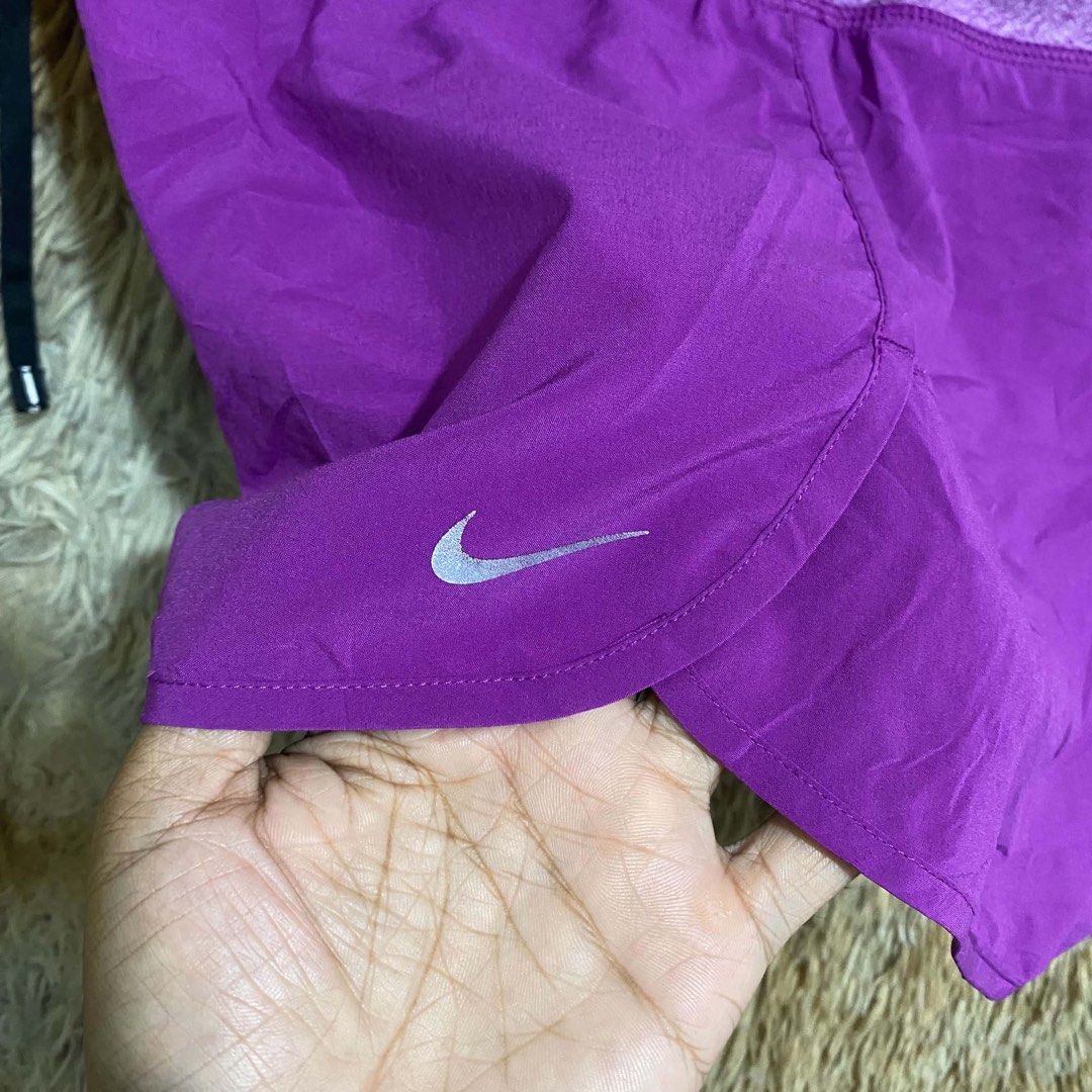 Nike Purple Running Shorts with Drawstring (Category: Activewear) located in Butuan. Submitted by jc13thrifts (Listing ID 1468709131, Image 3). Description: - Brand: Nike - Color: Vibrant purple with heathered waistband - Fit & Comfort: Lightweight fabric with adjustable drawstring - Design: Curved hem with reflective Nike swoosh logo - Storage: Small zipped pocket at the back waistband for keys or cards - Ideal For: Workouts, running, and casual