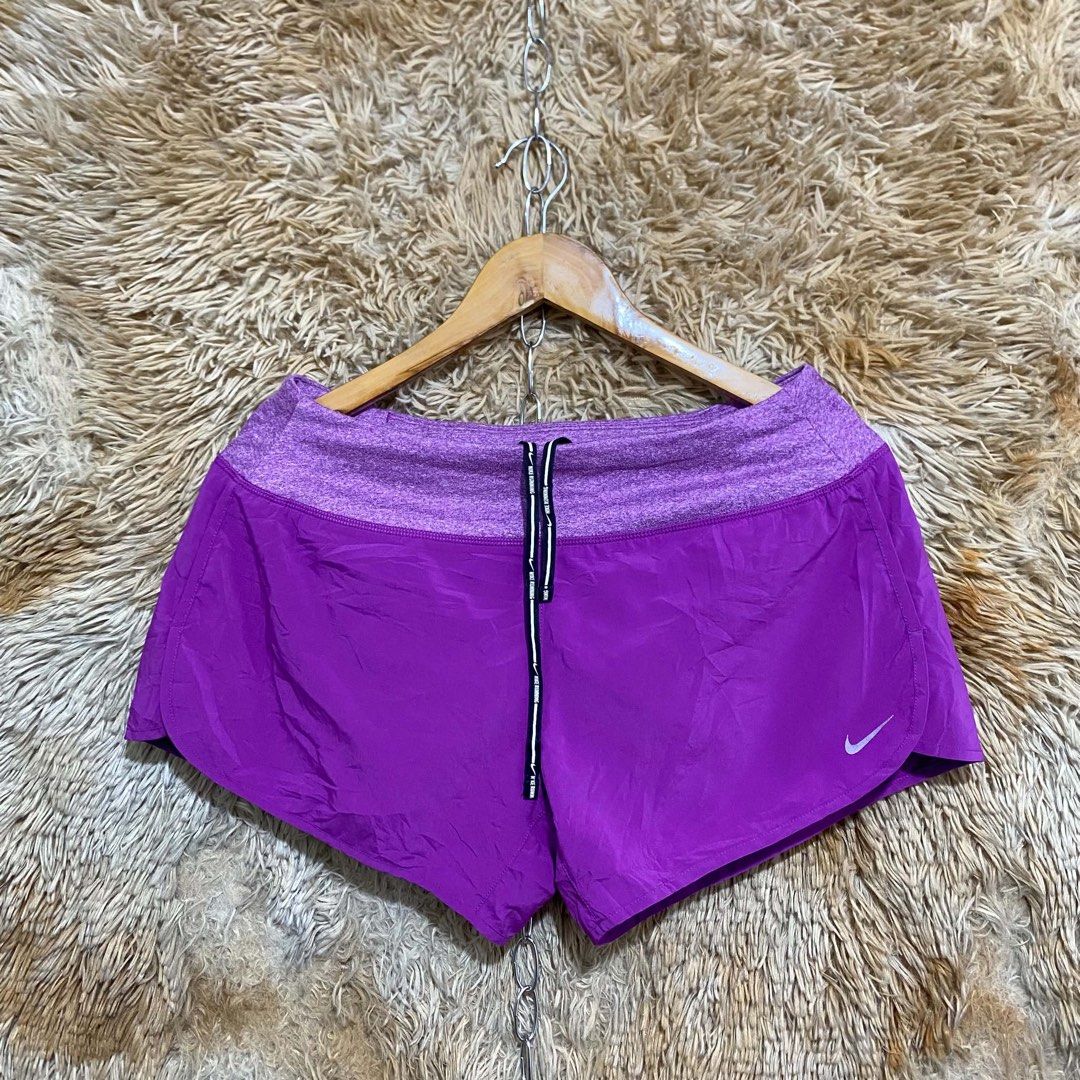 Nike Purple Running Shorts with Drawstring (Category: Activewear) located in Butuan. Submitted by jc13thrifts (Listing ID 1468709131, Image 1). Description: - Brand: Nike - Color: Vibrant purple with heathered waistband - Fit & Comfort: Lightweight fabric with adjustable drawstring - Design: Curved hem with reflective Nike swoosh logo - Storage: Small zipped pocket at the back waistband for keys or cards - Ideal For: Workouts, running, and casual