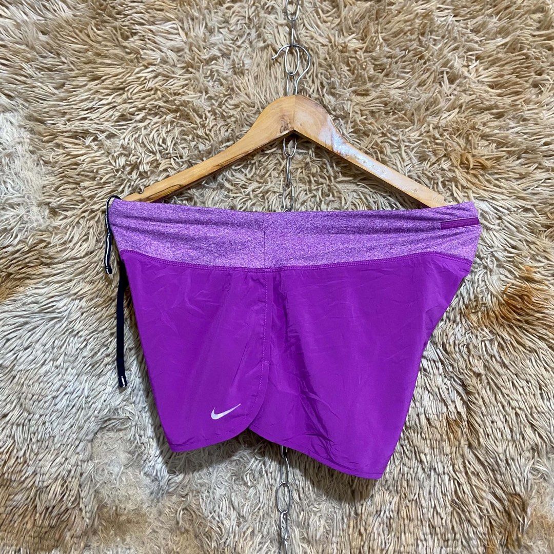 Nike Purple Running Shorts with Drawstring (Category: Activewear) located in Butuan. Submitted by jc13thrifts (Listing ID 1468709131, Image 2). Description: - Brand: Nike - Color: Vibrant purple with heathered waistband - Fit & Comfort: Lightweight fabric with adjustable drawstring - Design: Curved hem with reflective Nike swoosh logo - Storage: Small zipped pocket at the back waistband for keys or cards - Ideal For: Workouts, running, and casual