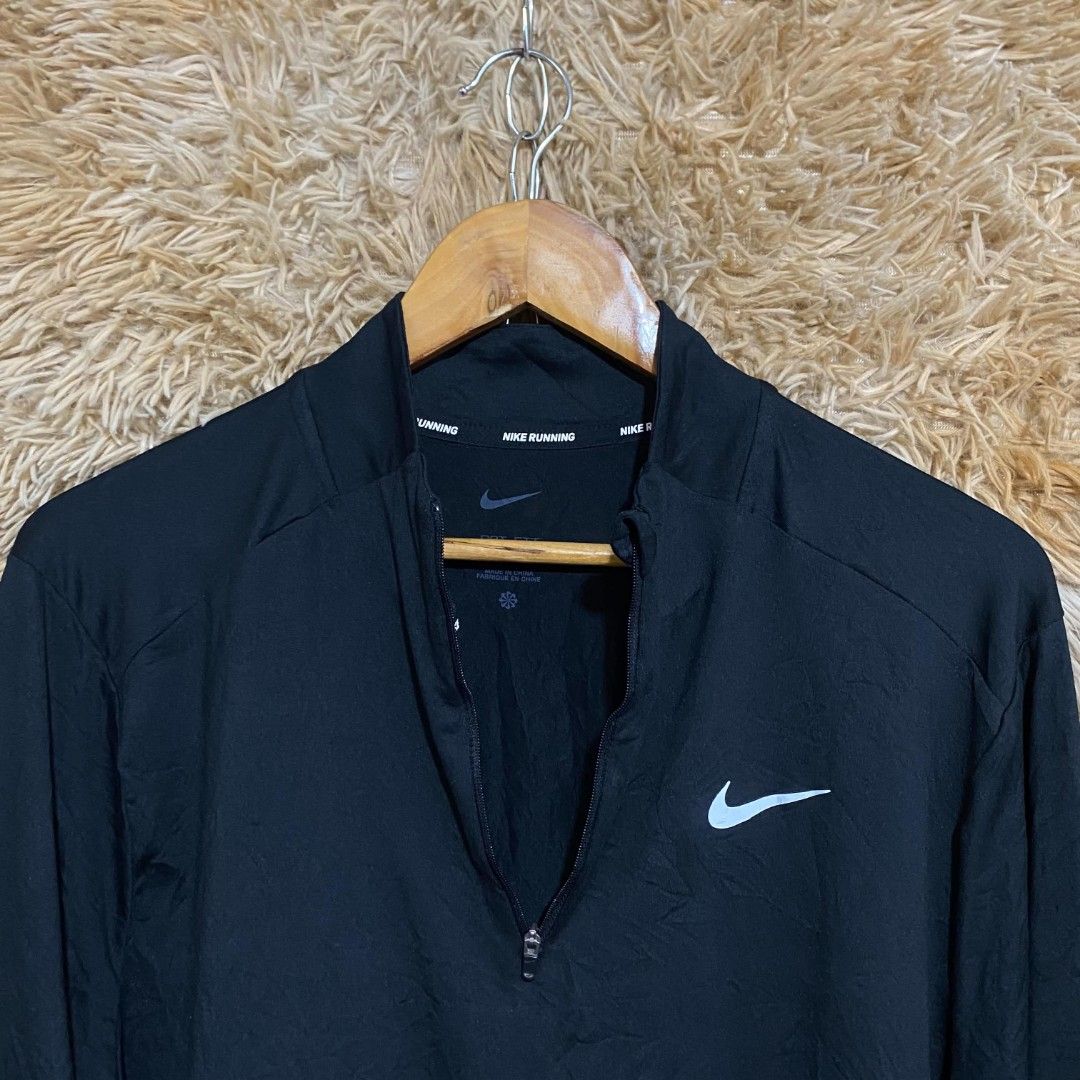 Nike Running Black 1/4 Zip Pullover Jacket (Category: Activewear) located in Butuan. Submitted by jcuabs041302 (Listing ID 1468669284, Image 3). Description: - Brand: Nike - Color: Classic Black - Style: Quarter-zip running pullover with high collar - Details: Iconic white swoosh logo on chest, 'Nike Running' text on inner neckline - Features: Lightweight workout fabric, long sleeves with thumbholes.