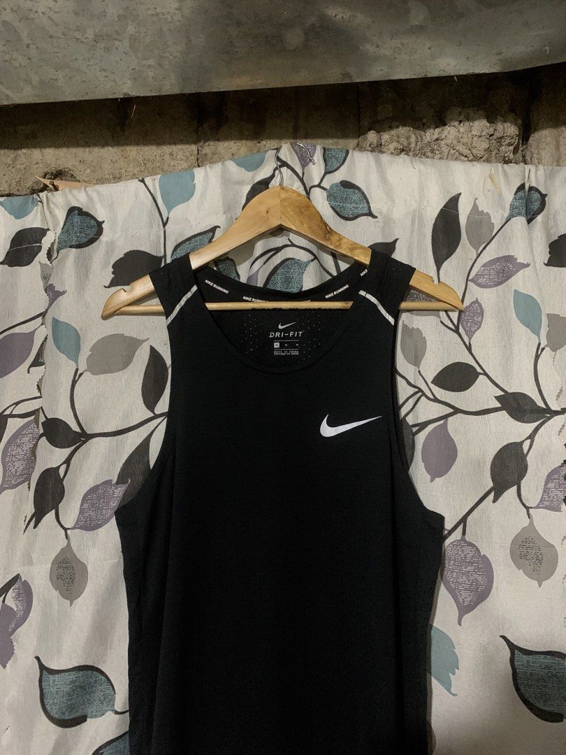 Nike Running Dri-FIT Black Tank Top Size M (Category: Activewear) located in Dumaguete. Submitted by grrrpowww (Listing ID 1468596176, Image 2). Description: Black Nike Running tank top in size medium. Dri-fit technology keeps you dry during workouts. Breathable perforated fabric all over. Nike swoosh printed on the chest. Nike Running taping along the inner neckline. Made in China. Style code AQ9918-010. Great workout piece..