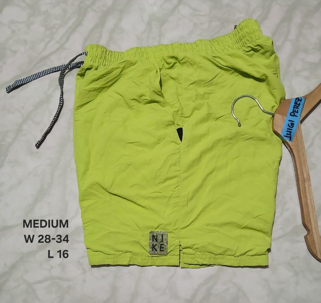 Nike Solid Icon 5" Volley Swim Shorts Green Medium (Category: Swim Trunks & Board Shorts) located in Plaridel. Submitted by igieperez147282 (Listing ID 1468659864, Image 1). Description: - Brand: Nike - Item: Volley Swim Shorts - Color: Bright Lime Green - Size: Medium (Waist fits approx. 28"-34", Length: 16") - Material: 100% Polyester (Made in Indonesia) - Features: Elastic waist, adjustable patterned drawstring, built-in mesh lining, and small