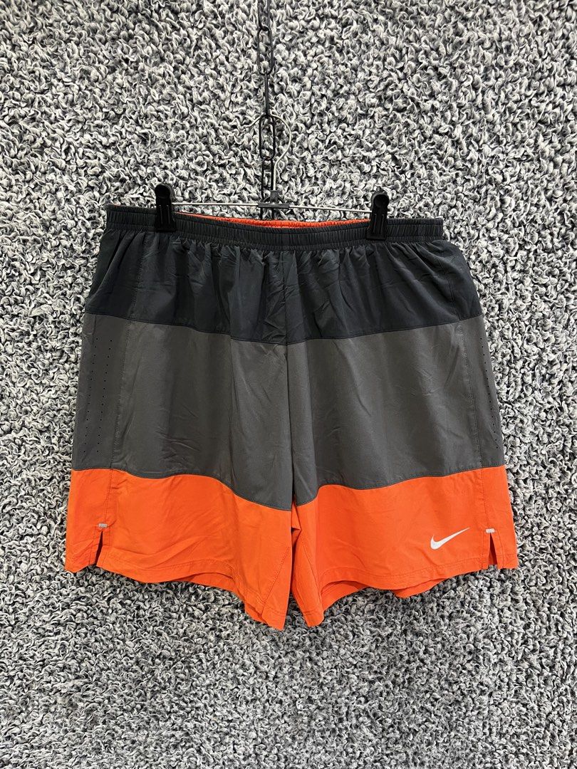 Nike Split Volley Shorts | Size L (Category: Shorts) located in General Trias. Submitted by zrchustle.604 (Listing ID 1468598896, Image 1). Description: the Nike Split Volley Shorts, a versatile athletic style designed for water and running activities. Key Features • Design: Color-blocked construction with a horizontal division. The top section is matte black, the middle band is a muted iron grey, and the lower half is vibrant bright orange. • Ma