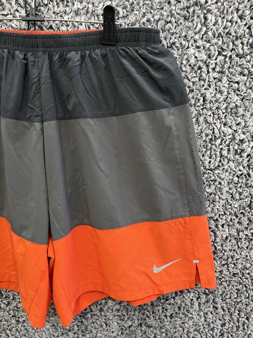 Nike Split Volley Shorts | Size L (Category: Shorts) located in General Trias. Submitted by zrchustle.604 (Listing ID 1468598896, Image 2). Description: the Nike Split Volley Shorts, a versatile athletic style designed for water and running activities. Key Features • Design: Color-blocked construction with a horizontal division. The top section is matte black, the middle band is a muted iron grey, and the lower half is vibrant bright orange. • Ma