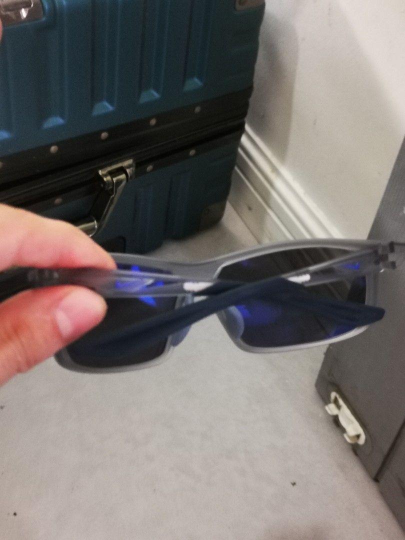 Nike Sunglasses Grey Blue Mirrored Lenses (Category: Sunglasses & Eyewear) located in Pasay City. Submitted by wizemindz138970 (Listing ID 1468589645, Image 2). Description: - Brand: Nike sunglasses - Frame: Dark grey with signature blue Nike swoosh on temples - Lenses: Blue mirrored, clean and scratch-free - Comfort: Non-slip rubber ear grips and nose pads - Usage: Ideal for outdoor sports and casual wear.