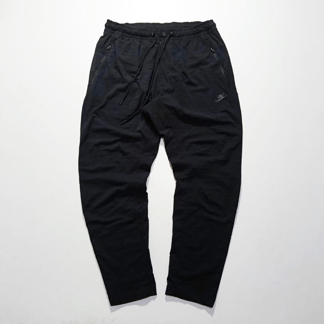 Nike Tech Street Black Trousers Embossed Logo (Category: Joggers) located in Taytay. Submitted by hoodgrail.vtg (Listing ID 1468608220, Image 1). Description: • Excellent condition - Like new • Lightweight nylon-stretch fabric, embossed Nike Swoosh logo, adjustable drawstring waist and zippered pockets • Size on tag: XL — best fits 32–34 • Measurements: 16 x 39 in • Leg opening: 6 in • Color rate: 9.5/10 • Issue: None.