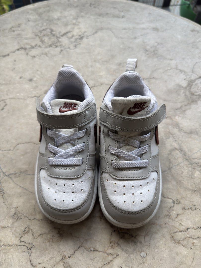 Nike Toddler Shoes Size US 8C (Category: Babies & Kids Fashion) located in Quezon City. Submitted by pamyeloo (Listing ID 1468557620, Image 1). Description: - Brand: Nike Toddler Shoes - Colorway: White, grey, and maroon - Size: US 8C / EUR 25 / 14 cm - Closure: Quick velcro strap over elastic laces for easy wear - Condition: Clean, worn only a few times, with plenty of tread left on the soles.
