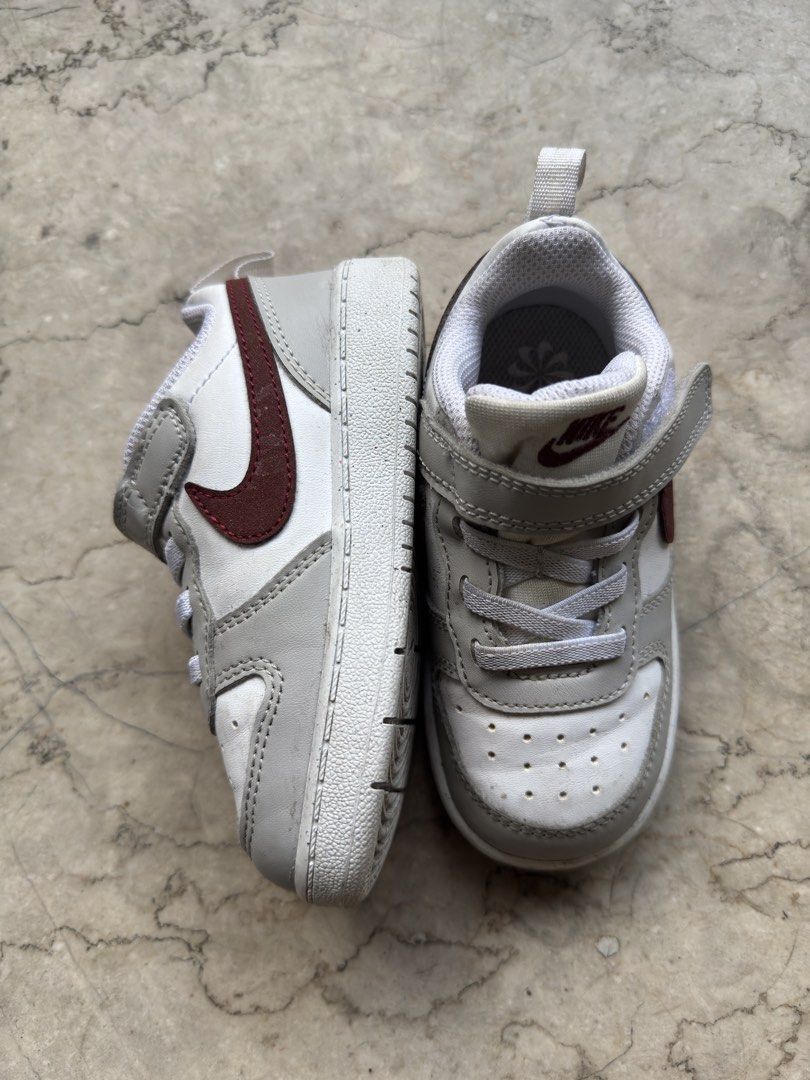 Nike Toddler Shoes Size US 8C (Category: Babies & Kids Fashion) located in Quezon City. Submitted by pamyeloo (Listing ID 1468557620, Image 2). Description: - Brand: Nike Toddler Shoes - Colorway: White, grey, and maroon - Size: US 8C / EUR 25 / 14 cm - Closure: Quick velcro strap over elastic laces for easy wear - Condition: Clean, worn only a few times, with plenty of tread left on the soles.
