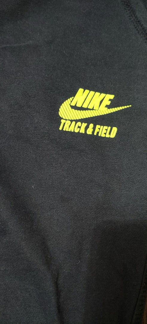 Nike Track & Field Black Sweatpants XXL (Category: Joggers) located in Manila. Submitted by snz_shop (Listing ID 1468533421, Image 2). Description: - Brand: Nike Track and Field - Size: XXL (Relaxed fit) - Color: Black with bright neon yellow logo - Waistband: Elastic with matching neon green drawstring - Pockets: Deep pockets on both sides - Material: Soft, warm inner fabric for maximum comfort - Condition/Origin: Made in China, great for workou