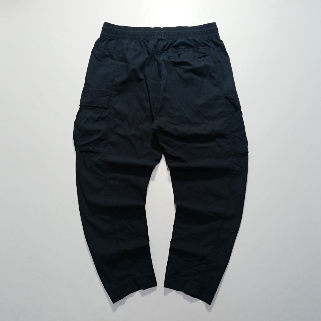 Nike Woven Cargo Pants with Zip Side Pocket (Category: Chinos) located in Taytay. Submitted by hoodgrail.vtg (Listing ID 1468623151, Image 2). Description: • Excellent condition - Like new • Black woven cargo pants featuring a zippered side pocket, utility cargo pockets, and Nike logo detailing • Size on tag: — best fits W32–34 (estimated; elastic waist) • Measurements: 16.5 x 39 in • Leg opening: 6.5 in • Color rate: 10/10 • Issue: Damaged edges