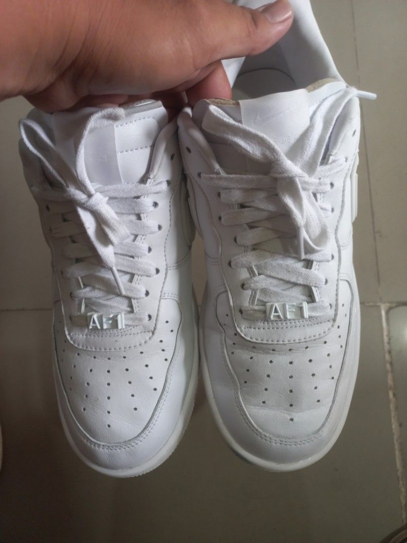 Nike x Ambush Air Force 1 Low White (Category: Sneakers) located in Kalibo. Submitted by jofit2ndhandshoes (Listing ID 1468676591, Image 3). Description: - Model: Nike Air Force 1 Low x Ambush - Colorway: Clean White - Size: 11 US - Condition: Excellent, minimal creasing on clean upper - Key Features: Distinctive chunky elongated swoosh, Ambush branding on heels, and classic AF1 metal dubraes - Comfort: Solid rubber cupsole equipped with signatur