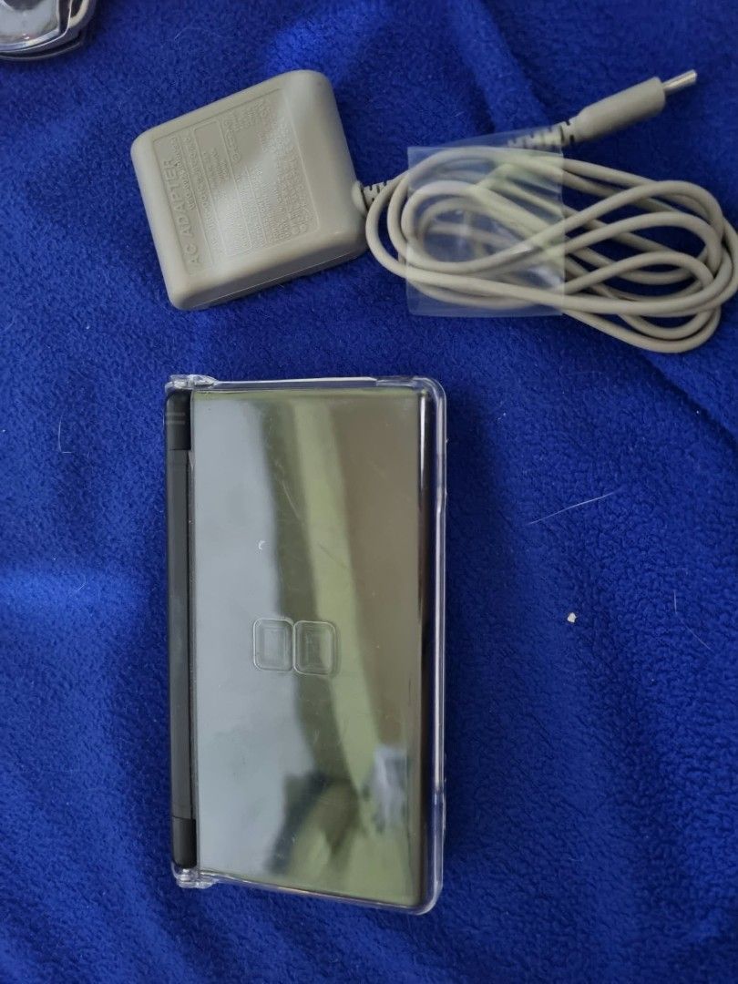 Nintendo DS Lite Black Handheld Console with Charger (Category: Nintendo) located in Angeles City. Submitted by roshangaming (Listing ID 1468569009, Image 2). Description: - Color: Classic Black - Condition: Fully working dual screens, clean buttons, and responsive d-pad - Inclusions: Original AC wall adapter charger and attached clear protective shell case - Authenticity: Serial number clearly readable on the back sticker - Ready-to-play portabl