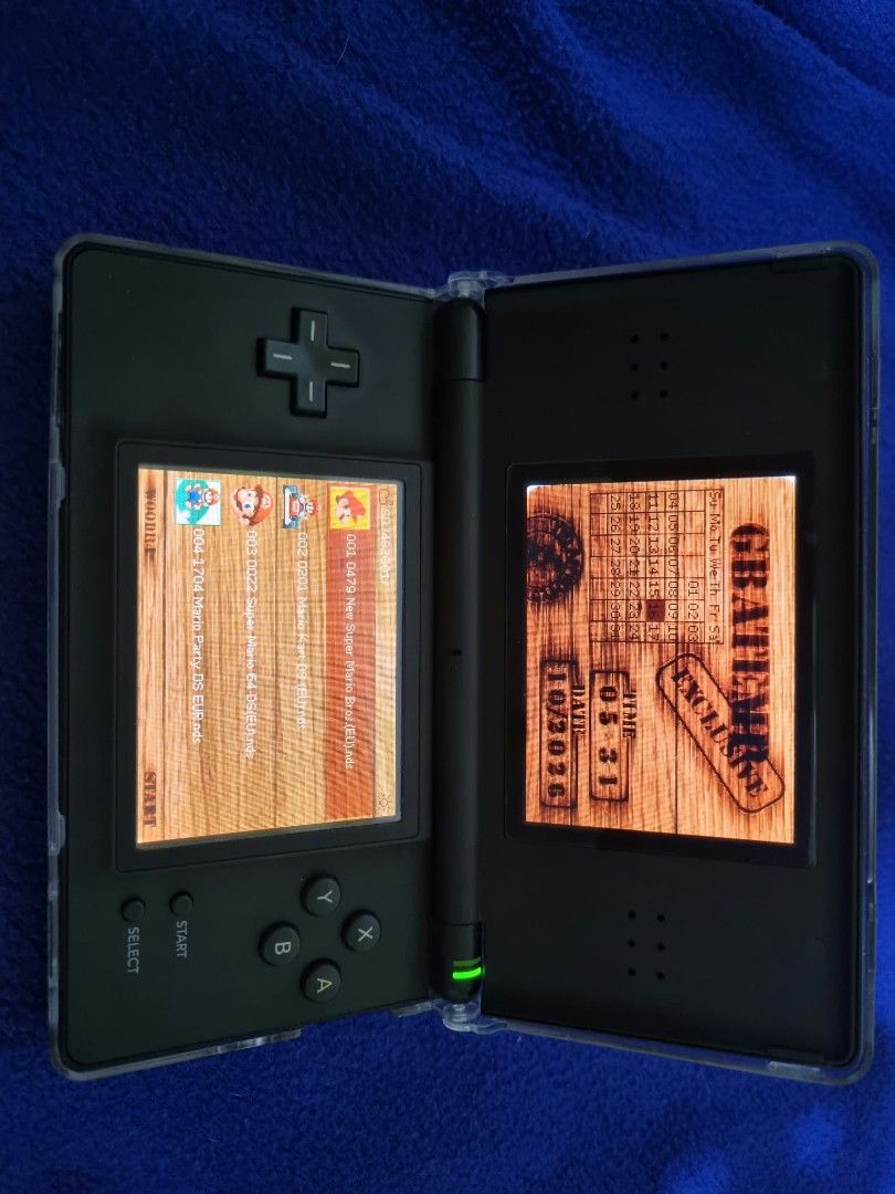 Nintendo DS Lite Black Handheld Console with Charger (Category: Nintendo) located in Angeles City. Submitted by roshangaming (Listing ID 1468569009, Image 3). Description: - Color: Classic Black - Condition: Fully working dual screens, clean buttons, and responsive d-pad - Inclusions: Original AC wall adapter charger and attached clear protective shell case - Authenticity: Serial number clearly readable on the back sticker - Ready-to-play portabl