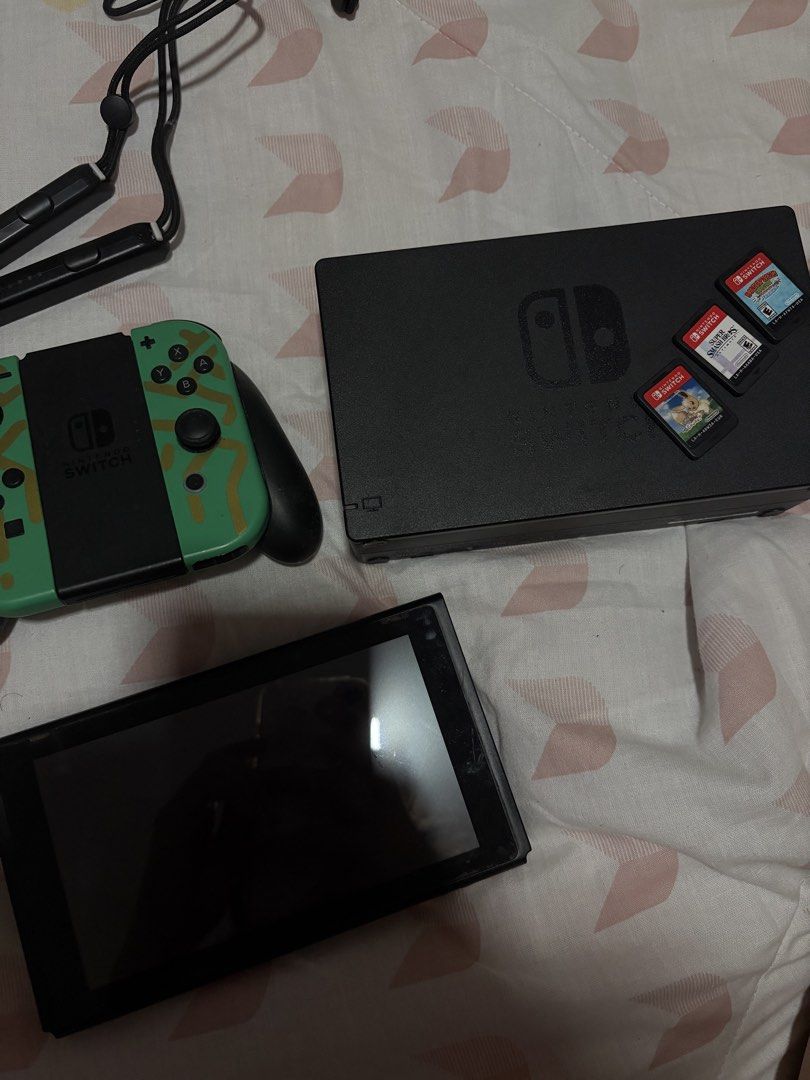 Nintendo Switch Console Bundle with Games and Joy-Cons (Category: Nintendo) located in Cavite. Submitted by Lexa_77 (Listing ID 1468654333, Image 1). Description: - Complete Nintendo Switch console with dock - Custom Green and Black Joy-Con controllers with wrist straps included - 3 physical game cartridges: Super Smash Bros Ultimate, Pokémon: Let's Go Eevee!, and Donkey Kong Country - Screen shows minor, normal signs of handling (doesn't affect 