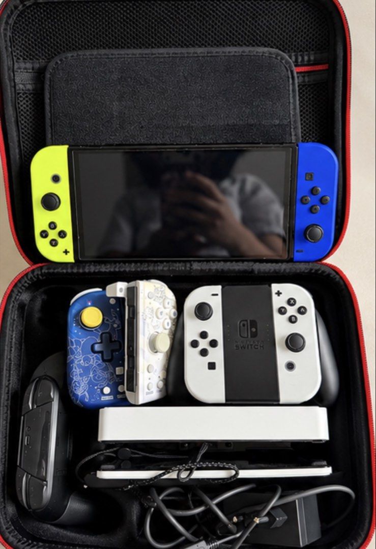 Nintendo Switch OLED Model Bundle with Pro Controller and Case (Category: Nintendo) located in Makati City. Submitted by shedecluttrs (Listing ID 1468641248, Image 1). Description: 🎮 FOR SALE: Nintendo Switch OLED Bundle Selling my pre-loved Nintendo Switch OLED with multiple controllers and accessories. Great for anyone looking for a complete gaming setup! INCLUSIONS: * Nintendo Switch OLED console * Neon Yellow & Blue Joy-Cons * White Joy-Cons