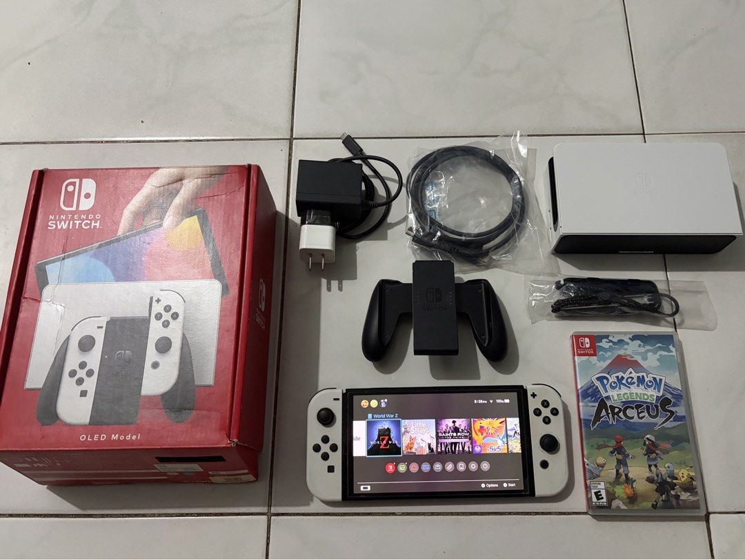 Nintendo Switch OLED (White) Complete Set + Games + 256GB SD Card (Category: Nintendo) located in Rizal. Submitted by corpo___chic (Listing ID 1468642227, Image 1). Description: Nintendo Switch OLED (White) – Complete Set + Games + 256GB SD Card INCLUSIONS: 1. Nintendo Switch OLED Console (White) – Fully functional, no issues 2. 256GB MicroSD Card 3. Pokémon Legends: Arceus (Physical Game Card) 4 Original Nintendo Switch Dock 5 Original Power Ada