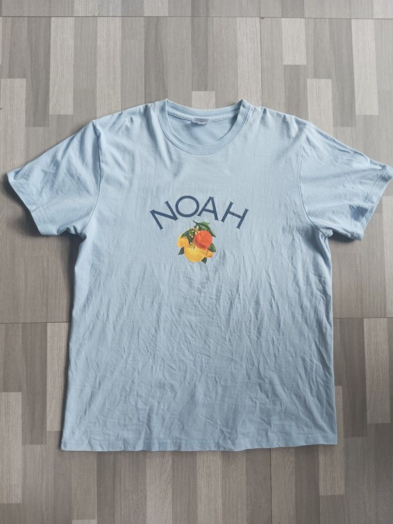 Noah NY Light Blue Fruit Graphic T-Shirt (Category: Tshirts & Polo Shirts ) located in Manila. Submitted by charleshustla (Listing ID 1468534574, Image 1). Description: - Brand: Noah - Color: Light blue with fruit graphic on chest - Material: 100% cotton (Made in Honduras) - Style: Classic crewneck, short sleeve t-shirt - Size: Medium.