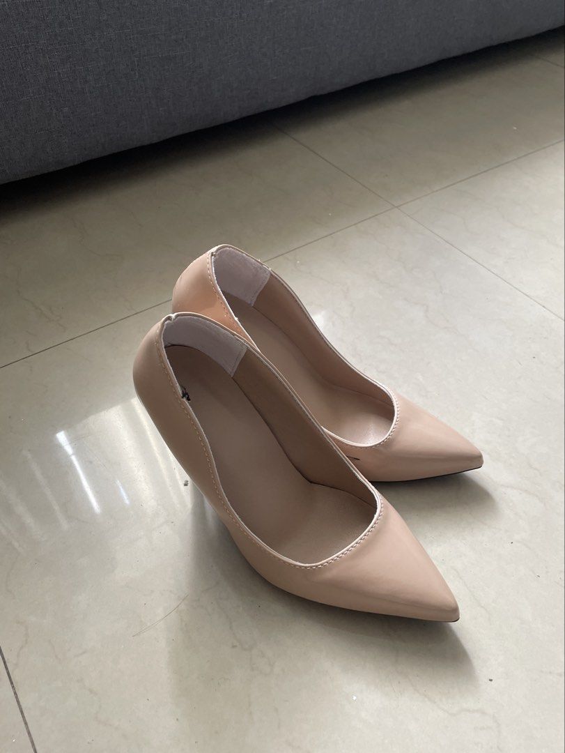 Nude patent leather pointed toe stiletto heels (Category: Heels) located in Quezon City. Submitted by thriftydreams (Listing ID 1468504618, Image 1). Description: - Classic nude patent leather stiletto heels - Elegant pointed toe design with a high, slim heel - Versatile neutral shade that matches any outfit for work or dinner - Clean interior lining with a glossy outer finish - Easy slip-on style.