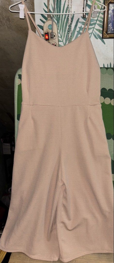 Nude spaghetti strap wide leg jumpsuit (Category: Jumpsuits) located in Manila. Submitted by whatspoppin3000 (Listing ID 1468586648, Image 1). Description: - Color: Nude - Style: Spaghetti strap jumpsuit with wide cropped legs - Fit: Fitted bodice with a defined waistline and crossed back straps - Fabric: Lightweight with a slight texture, super comfy for warm weather - Versatility: Clean, simple design that's easy to dress up or down.