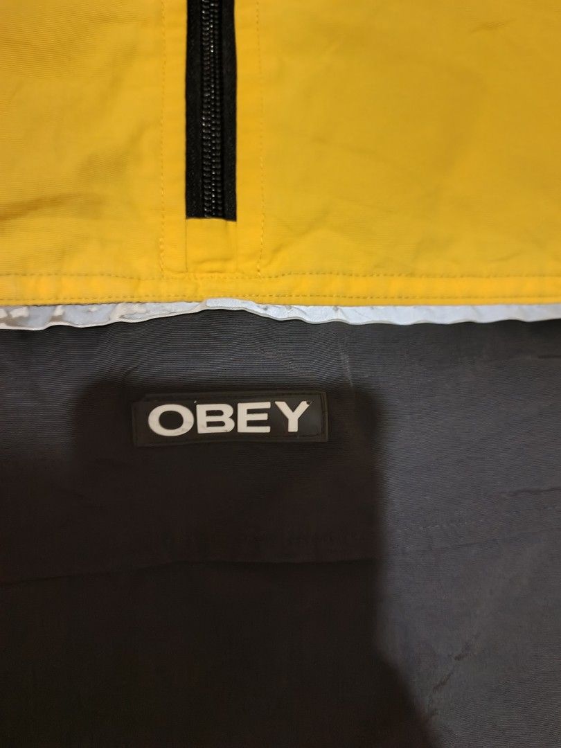 OBEY (Category: Coats, Jackets and Outerwear) located in Calabanga. Submitted by just-thrift (Listing ID 1468631062, Image 3). Description: PM ME SA IBANG DETAILS OBEY Worldwide Yellow & Black Colorblock Anorak Windbreaker Jacket ‎GOOD CONDITION ‎COLOR RATE: 8.5/10 ‎SIZE:LARGE ON TAG ‎ISSUE:STAIN NEED WASH, PINHOLE AND BAKBAK SA REFLECTIVE PRINT ‎DIMES:25/28 ‎SLEEVE:24.