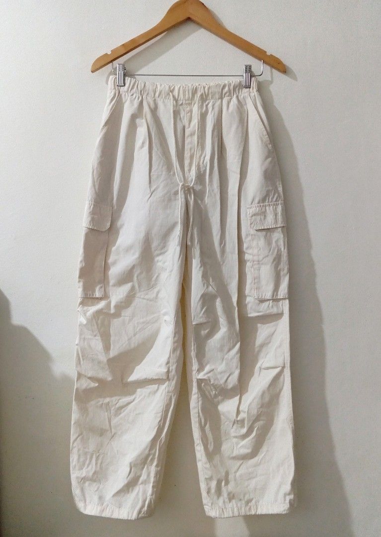 Off-white cargo pants with drawstring and utility pockets (Category: Joggers) located in Manila. Submitted by cococlo_ (Listing ID 1468658590, Image 1). Description: - Color: Off-white / Neutral - Waist: Elastic waistband with adjustable front drawstring - Pockets: Multiple utility pockets with side flap closures - Fit: Straight-leg cut with a roomy, comfortable fit - Styling: Great everyday staple that easily pairs with basics, tees, and hoodies