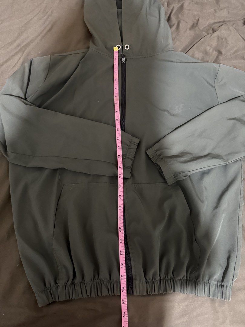 Olive green hooded zip-up windbreaker jacket (Category: Coats, Jackets and Outerwear) located in Quezon City. Submitted by turtleandfishes (Listing ID 1468629723, Image 3). Description: - Color: Olive green - Style: Full-zip jacket with built-in hood and chin drawstrings - Comfort: Elasticized cuffs and gathered elastic hem for a snug fit - Pockets: Two functional side welt pockets - Fabric: Lightweight and easy to throw on for breezy days.