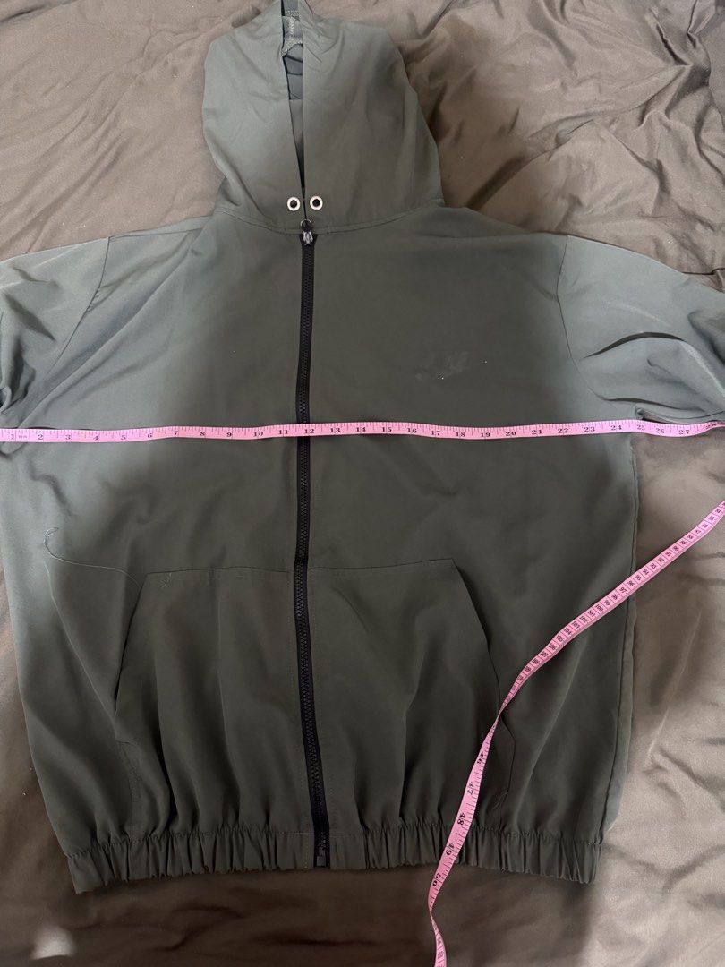 Olive green hooded zip-up windbreaker jacket (Category: Coats, Jackets and Outerwear) located in Quezon City. Submitted by turtleandfishes (Listing ID 1468629723, Image 2). Description: - Color: Olive green - Style: Full-zip jacket with built-in hood and chin drawstrings - Comfort: Elasticized cuffs and gathered elastic hem for a snug fit - Pockets: Two functional side welt pockets - Fabric: Lightweight and easy to throw on for breezy days.