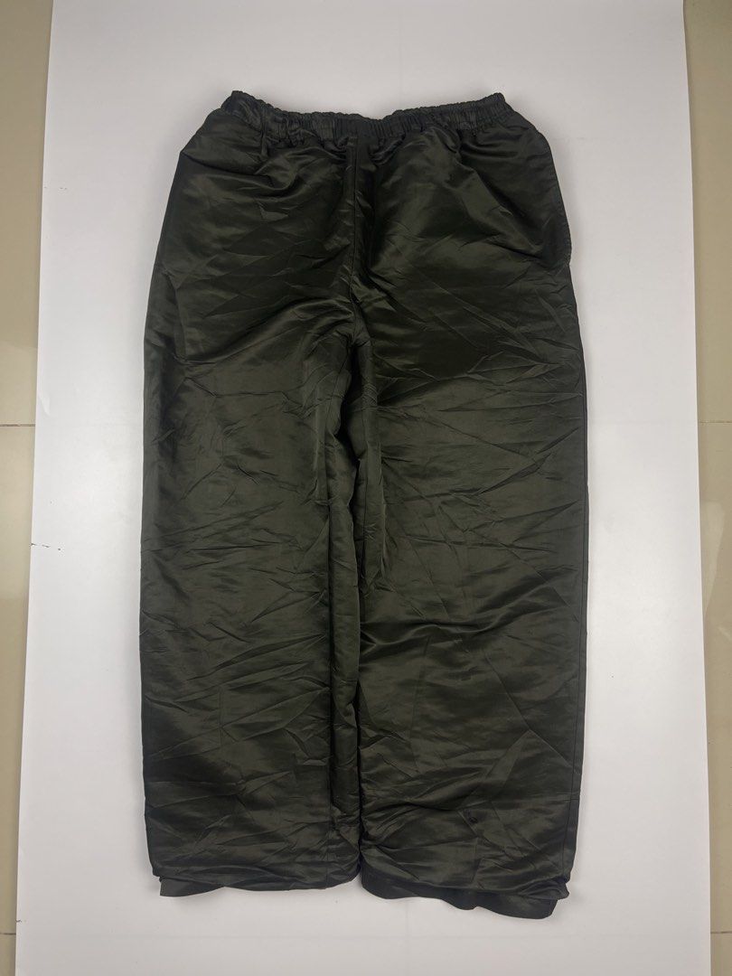 OLIVE GREEN PUFFER / NYLON PARACHUTE TRACK PANTS (Category: Jeans) located in Cagayan de Oro. Submitted by kmcurations (Listing ID 1468557823, Image 1). Description: OLIVE GREEN PUFFER / NYLON PARACHUTE TRACK PANTS Details & Dimensions: • Material: Padded / insulated nylon-polyester shell with subtle sheen in deep olive / army green • Cut/Fit: Baggy wide-leg parachute / balloon silhouette with double-cuff leg opening • Waist: Full elastic waistba