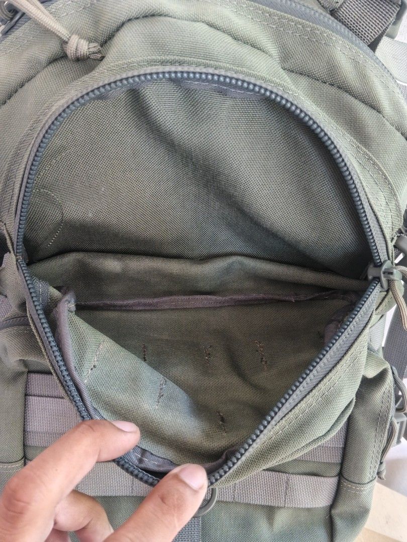 MAGFORCE Olive Green Tactical MOLLE Backpack (Category: Backpacks) located in Tanza. Submitted by antares0048 (Listing ID 1468508785, Image 2). Description: - Color: Green - Durable fabric built for heavy outdoor use - Multiple compartments with webbing straps - Front pockets feature internal organizers and key loops - Main compartment includes a mesh pocket and dividers - Adjustable side compression straps to manage volume - Message us for quest