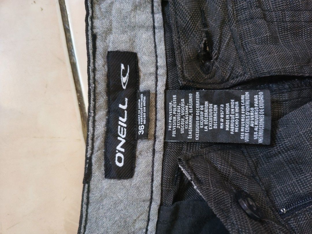 O'Neill Men's Black Patterned Shorts Size 36 (Category: Shorts) located in Munoz. Submitted by toy_zone (Listing ID 1468503127, Image 3). Description: - Brand: O'Neill - Color: Dark grey patterned - Size: 36 waist - Material: 78% polyester, 21% viscose, 1% elastane blend (Made in India) - Closure: Button closure with zipper fly - Pockets: Two back pockets with secure button flaps - Condition/Use: Perfect for comfortable, everyday casual wear.