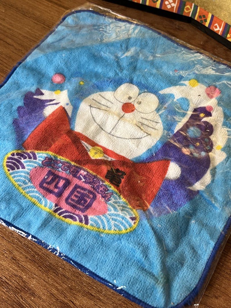 Original Japan Doraemon Mini Towel (Category: Towels, Napkins & Holders) located in Gapan. Submitted by lunashop14 (Listing ID 1468693130, Image 2). Description: - 100% authentic Doraemon mini towel with Shikoku regional design - Made in Japan with high-quality terry cloth - Brand new, unopened in original plastic packaging with store sticker - Official Shopro merchandise manufactured by Epoch - Perfect for collectors and daily use.
