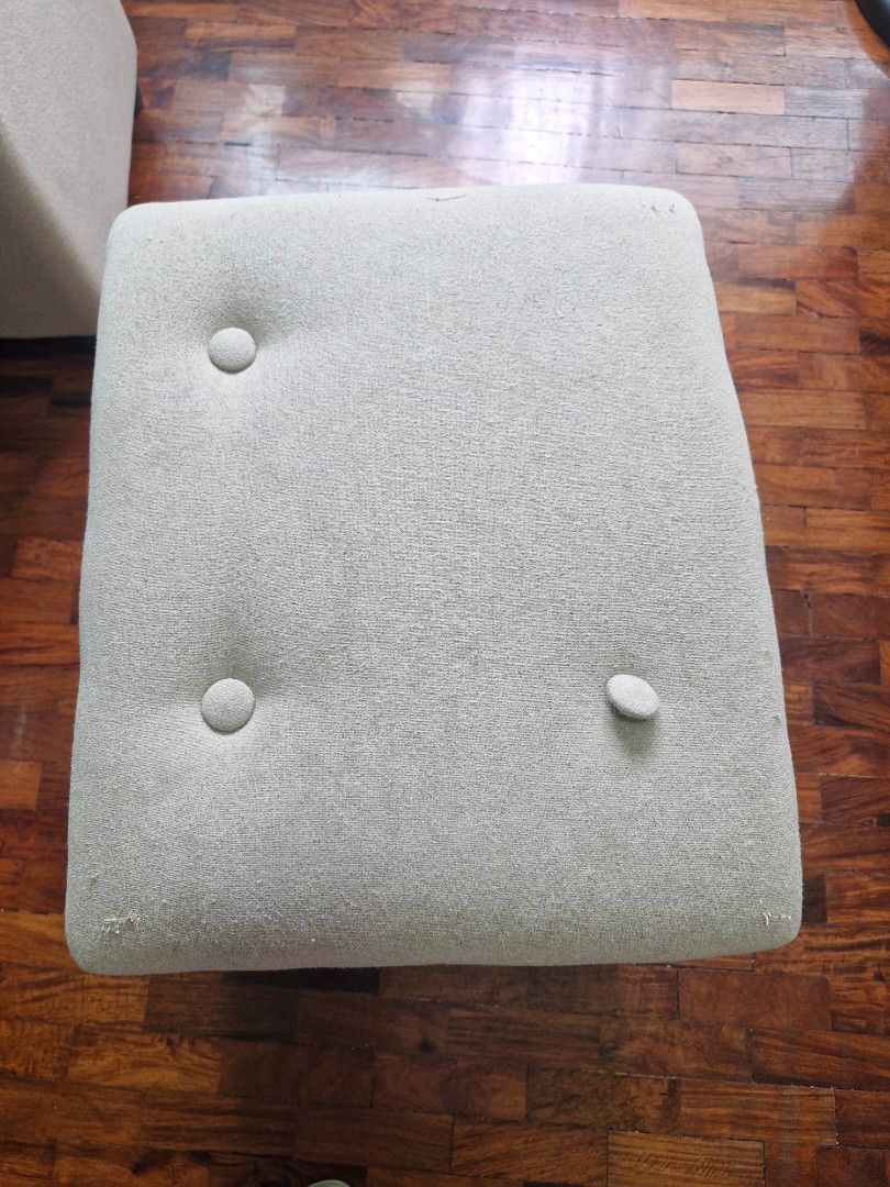 Pair of storage ottomans (Category: Chairs) located in Quezon City. Submitted by acey18 (Listing ID 1468508224, Image 3). Description: size (LWH): 40cm x 50cm x 45cm - Color: Neutral beige - Material: Fabric with button tufting - Condition: Decent, with minor wear from regular use, has missing buttons (you can remove it and it wont affect its function) - Features: Solid and sturdy structure - Uses: Great as a footstool or extra seating for living