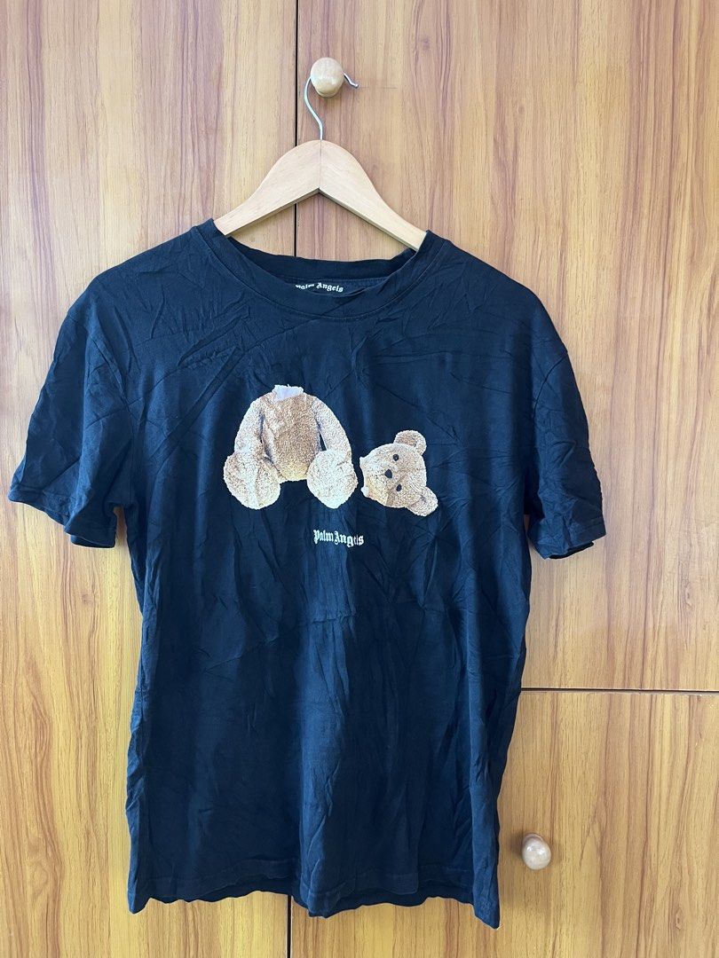 Palm Angels Bear T-Shirt Black (Category: Tshirts & Polo Shirts ) located in Manila. Submitted by christian048 (Listing ID 1468642360, Image 3). Description: - Brand: Palm Angels - Color: Classic Black - Design: Signature headless bear graphic on the front with bold gothic text logo across the upper back - Fit: Short sleeves, classic crew neck - Material: Premium soft cotton - Style: Iconic streetwear piece - Condition: Excellent / Ready to wear 