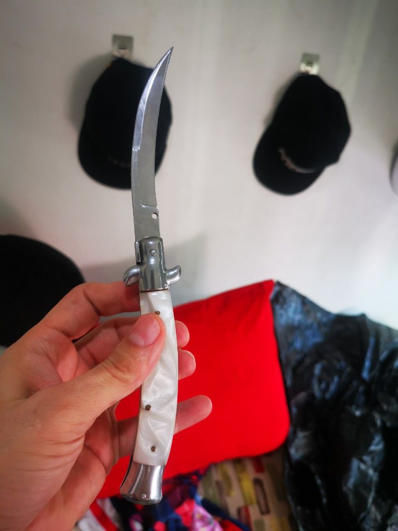 Pearl handle folding pocket knife with curved blade (Category: Knives & Chopping Boards) located in Pasay City. Submitted by wizemindz138970 (Listing ID 1468589397, Image 2). Description: - Elegant white pearlescent handle with shiny metal bolsters - Smooth-opening curved blade with a secure lock mechanism - Compact and pocket-friendly size for everyday carry - Solid, sturdy build that feels great in the hand - Clean condition with minimal signs 