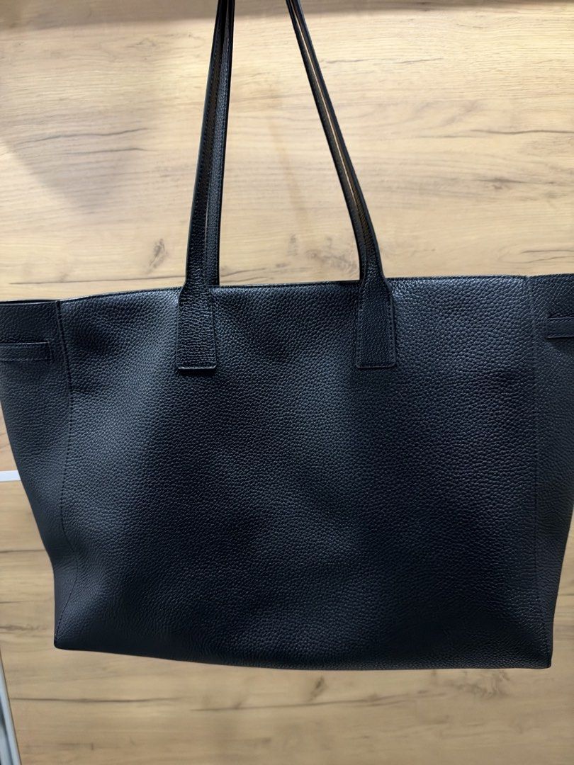 Pedro Black Demi Oversized (Category: Tote Bags) located in Pasig City. Submitted by hshmt (Listing ID 1468601924, Image 3). Description: Black pebble leather tote bag from Pedro. Structured shape with twin shoulder straps. Decorative front belt detail with knot and silver hardware. Spacious main interior compartment with embossed logo branding on the base. Clean textured finish all over. Bought last September @BGC.
