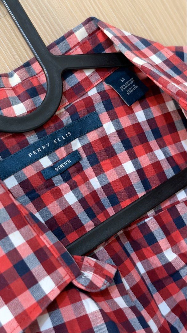 Perry Ellis Stretch Red Polo (Category: Tshirts & Polo Shirts ) located in Quezon City. Submitted by declutterw_v (Listing ID 1468682015, Image 3). Description: - Brand: Perry Ellis - Style: Short sleeve button-down shirt - Pattern: Red, white, and navy blue checkered plaid - Size: Medium - Material: 98% cotton, 2% elastane (stretch blend) - Origin: Made in Indonesia - Condition: Clean fabric with clear branding tags.