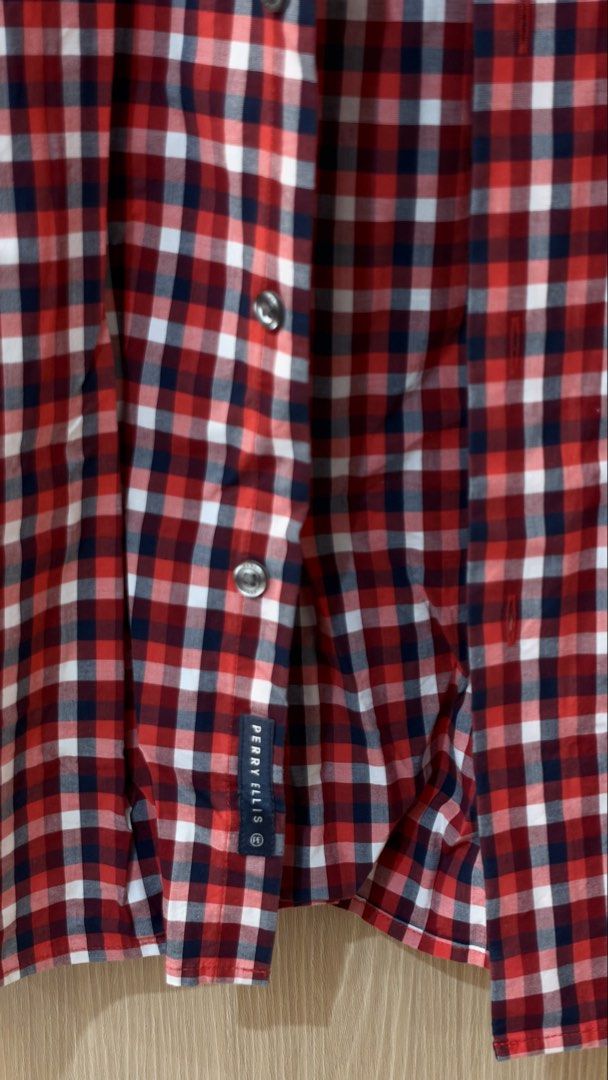 Perry Ellis Stretch Red Polo (Category: Tshirts & Polo Shirts ) located in Quezon City. Submitted by declutterw_v (Listing ID 1468682015, Image 2). Description: - Brand: Perry Ellis - Style: Short sleeve button-down shirt - Pattern: Red, white, and navy blue checkered plaid - Size: Medium - Material: 98% cotton, 2% elastane (stretch blend) - Origin: Made in Indonesia - Condition: Clean fabric with clear branding tags.