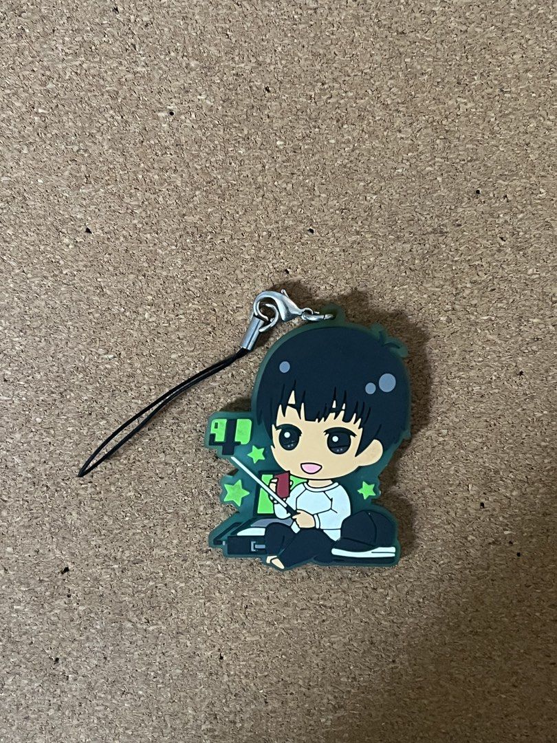 Phichit Chulanont Rubber Keychain Strap Yuri on Ice (Category: Character Goods) located in Baguio. Submitted by gaara1234 (Listing ID 1468526432, Image 1). Description: - Cute chibi anime character design sitting and holding a stick - Aesthetic green theme with stars and gaming/streaming setup background - Durable rubber material in clean, well-maintained condition - Includes a black strap with a secure metal clasp - Great for decorating keys, ba