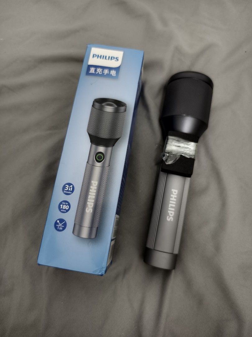 Philips Rechargeable Flashlight with Box (Category: Lighting) located in Angeles City. Submitted by measaliman02351 (Listing ID 1468629497, Image 2). Description: - Brand new Philips rechargeable flashlight with a durable grey metal body - Unboxed only for photos, never used - 3 adjustable light modes to suit your needs - Long-lasting battery with up to 180 minutes of runtime - Built tough with drop resistance up to 1 meter - Comes complete with 