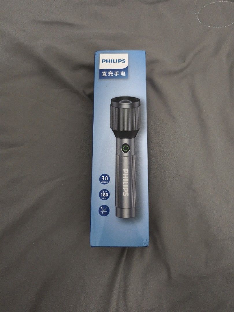 Philips Rechargeable Flashlight with Box (Category: Lighting) located in Angeles City. Submitted by measaliman02351 (Listing ID 1468629497, Image 1). Description: - Brand new Philips rechargeable flashlight with a durable grey metal body - Unboxed only for photos, never used - 3 adjustable light modes to suit your needs - Long-lasting battery with up to 180 minutes of runtime - Built tough with drop resistance up to 1 meter - Comes complete with 