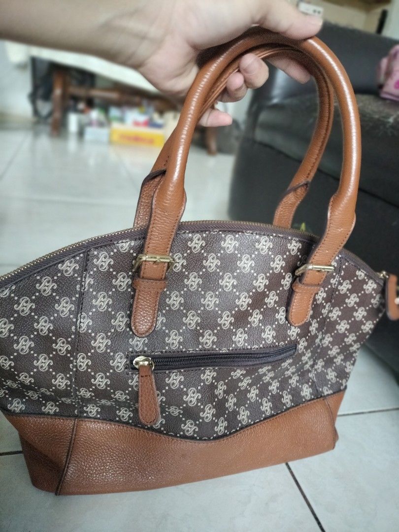 Mark down..From 680-580!!Pierre Cardin Paris brown monogram print handbag (Category: Luxury Bags & Wallets) located in Leyte. Submitted by janiceql8414443 (Listing ID 1468565684, Image 3). Description: - Brand: Pierre Cardin Paris - Design: Classic brown monogram pattern with tan leather handles and base panel - Closure: Secure top zip closure - Pockets: Front exterior zip pocket for easy access - Interior: Dark fabric lining with authentic leath