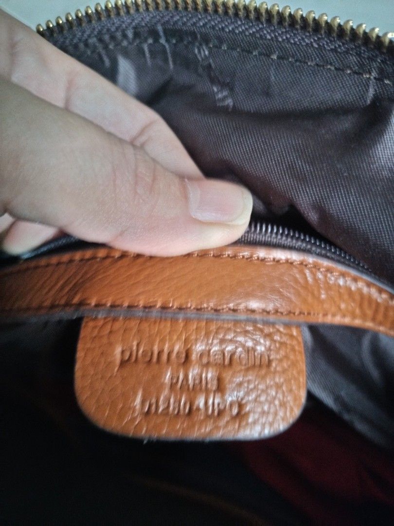 Mark down..From 680-580!!Pierre Cardin Paris brown monogram print handbag (Category: Luxury Bags & Wallets) located in Leyte. Submitted by janiceql8414443 (Listing ID 1468565684, Image 2). Description: - Brand: Pierre Cardin Paris - Design: Classic brown monogram pattern with tan leather handles and base panel - Closure: Secure top zip closure - Pockets: Front exterior zip pocket for easy access - Interior: Dark fabric lining with authentic leath