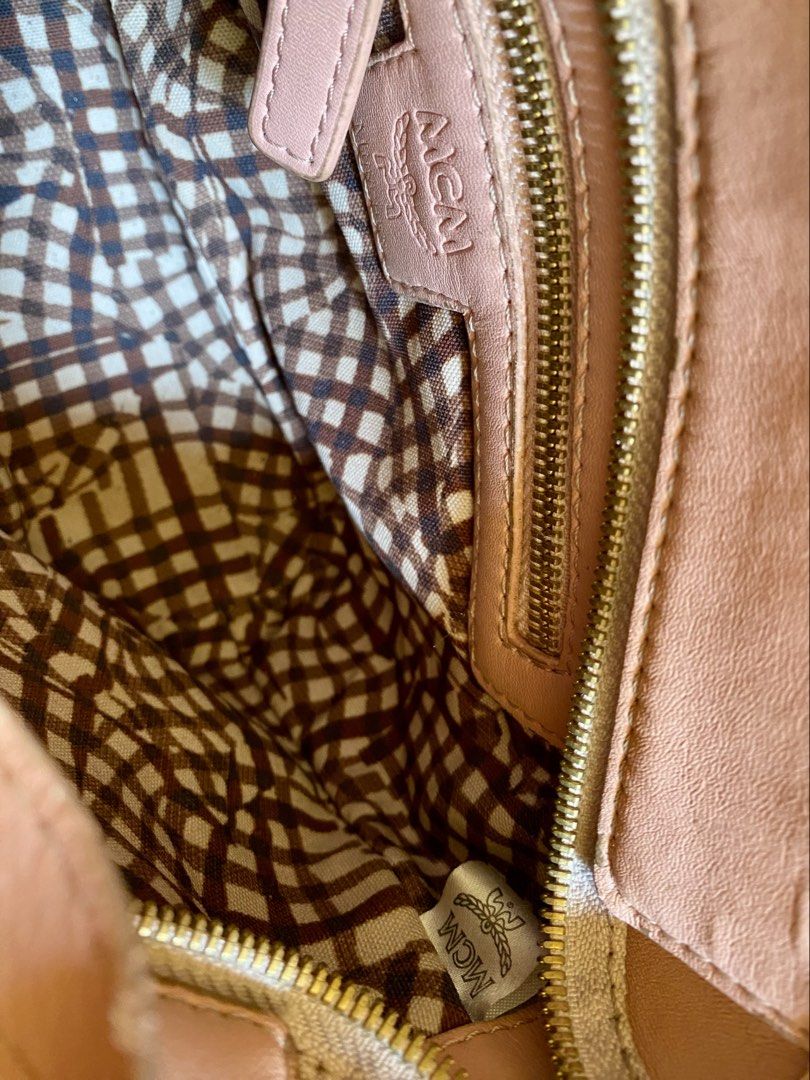 Pink MCM Monogram mini sling bag (Category: Shoulder Bags) located in Baguio. Submitted by vintagefox (Listing ID 1468556754, Image 3). Description: - Brand: MCM - Color: Pink with classic monogram print - Hardware: Gold-tone with stylish stud accents - Straps: Dual top handles and a detachable shoulder strap - Interior: checkered lining with secure zippered pockets - Size: small (fits daily essentials easily) -preloved with signs of use, some fa