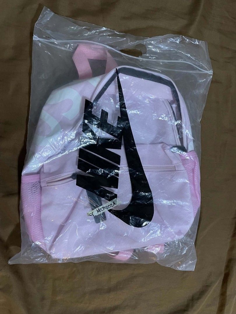 Pink Nike Backpack With Just Do It Keychain (Category: Backpacks) located in Iloilo. Submitted by lovedbymyl (Listing ID 1468601256, Image 2). Description: Nike Brasilia Mini Backpack – Pink Pretty in pink! 🎀— Light pink with a white swoosh logo • Almost brand new— Only opened, with the tag already cut (bought last week) • Cute, compact, and perfect for everyday use— can be used by adults & kids𐔌՞ ܸ.ˬ.ܸ՞𐦯 •Includes: main zipper compartment, fr
