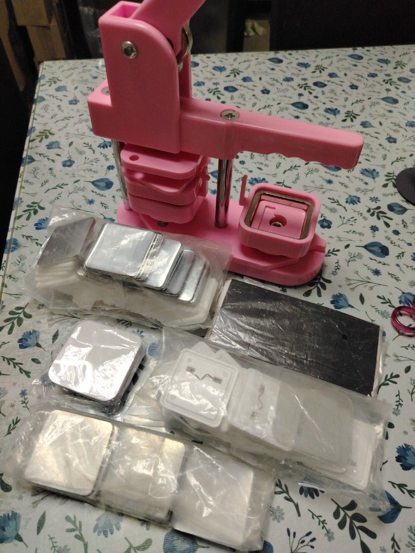 Pink Square Button Badge Maker Machine with Supplies (Category: Craft Supplies & Tools) located in Castillejos. Submitted by jheaya (Listing ID 1468530832, Image 1). Description: - Pink square button badge maker machine with heavy-duty metal press and ergonomic handle - Includes a square die set for perfect cuts every time - Comes with multiple packs of unpressed badge components (metal fronts, plastic backs, and clear films) - Ideal for DIY craf