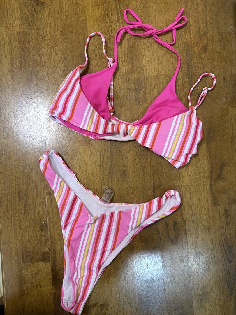 Pink Striped Two-Piece Bikini (Category: Bikinis & Swimsuits) located in Makati City. Submitted by shoprory (Listing ID 1468596782, Image 1). Description: - Pink striped bikini set with vibrant multi-colored vertical stripes (pink, orange, yellow, white) - Triangle top with adjustable halter ties and secure back closure - Matching high-cut bottoms for a flattering silhouette - Fully lined interior for comfort and coverage - Brand new with standar