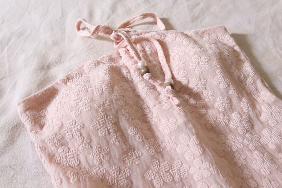 Pink Textured Halter Top with Beaded Strings (Category: Sleeveless) located in Manila. Submitted by imama23 (Listing ID 1468535604, Image 2). Description: - Color: Light pink - Details: Adjustable neck ties adorned with padded front Condition: 9/10 Size: XS-S Location: Manila Shipping - Payment first before shipping - J&T, Grab, Lalamove (Buyer may choose preferred courier) - MOP: GCASH, Bank Transfer - Shipping to be shouldered by buyer .